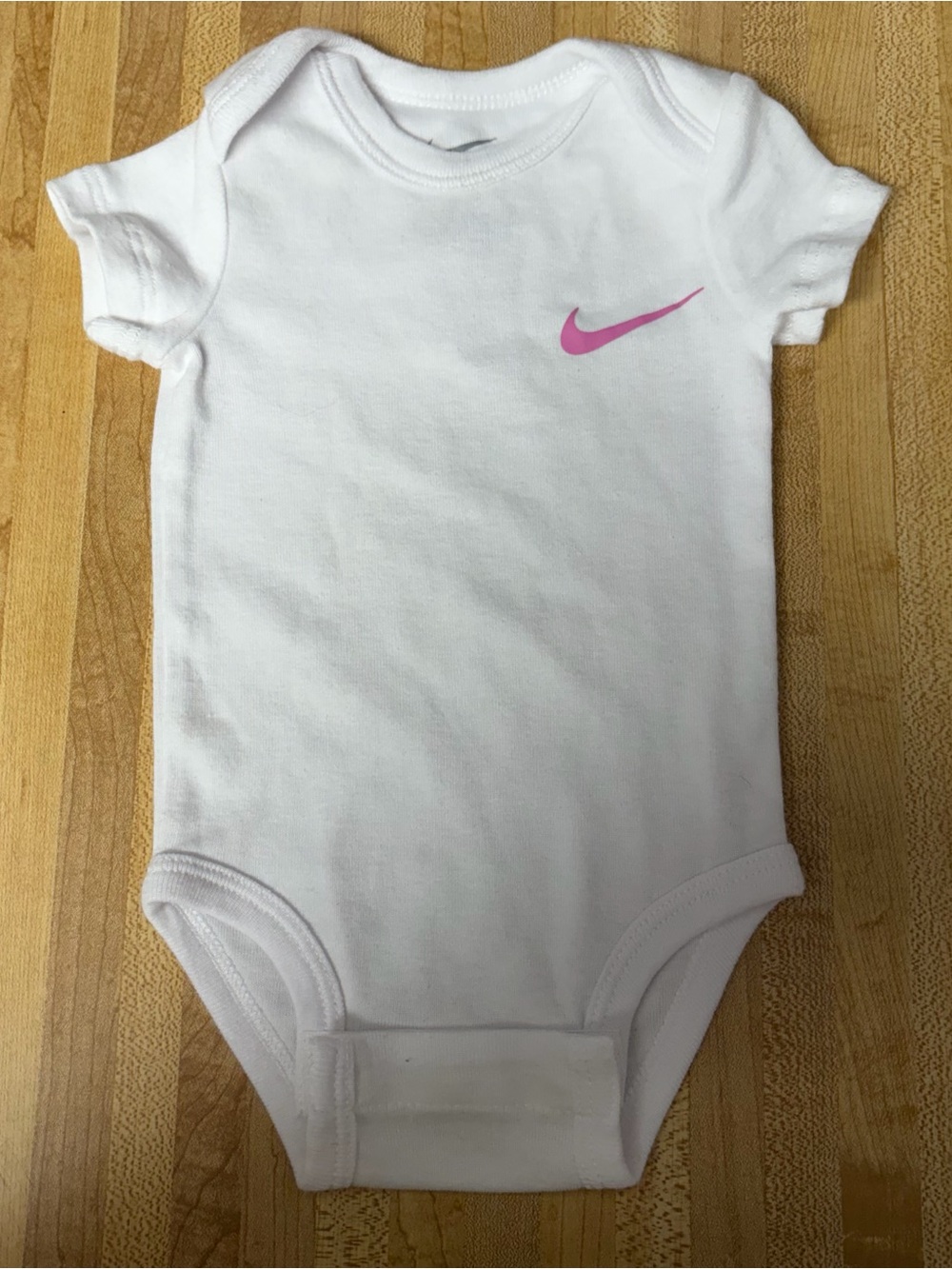 Nike White Baby Bodysuit with Pink Swoosh
